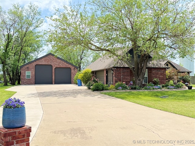 single story home featuring brick siding, a detached garage, a front lawn, and an outdoor structure