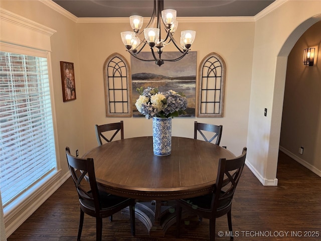 dining area featuring arched walkways, a notable chandelier, dark wood-type flooring, and baseboards