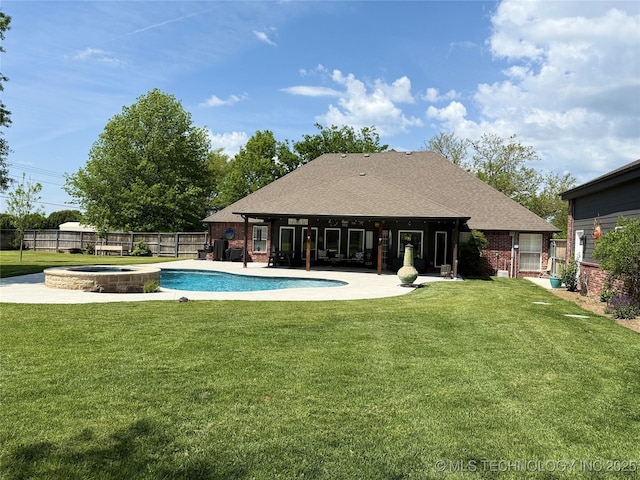 view of swimming pool with a fenced backyard, a yard, a patio, and a pool with connected hot tub