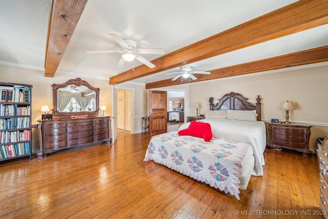 bedroom featuring ornamental molding, beam ceiling, and hardwood / wood-style floors