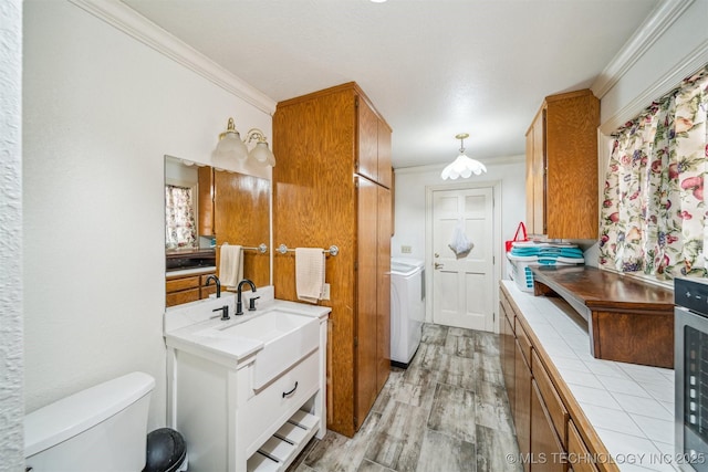 interior space featuring tile countertops, light wood-type flooring, brown cabinetry, and crown molding