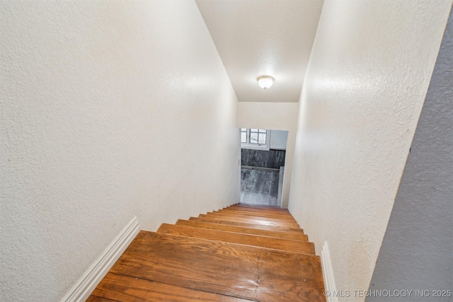 staircase with a textured wall