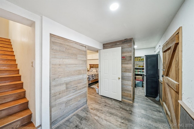 hall with stairs, wood finished floors, and recessed lighting