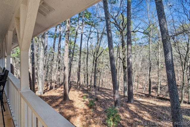 view of yard featuring visible vents and a wooded view