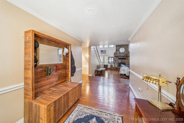 hall featuring stairs, ornamental molding, wood finished floors, and baseboards