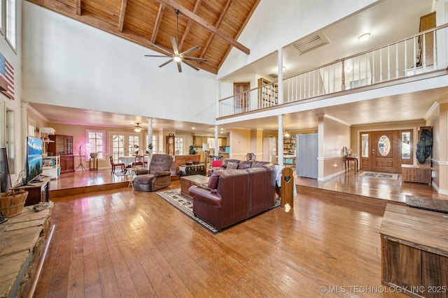 living area with visible vents, wood ceiling, ceiling fan, high vaulted ceiling, and hardwood / wood-style floors