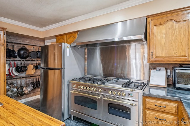 kitchen with range with two ovens, ornamental molding, decorative backsplash, wall chimney exhaust hood, and dark countertops