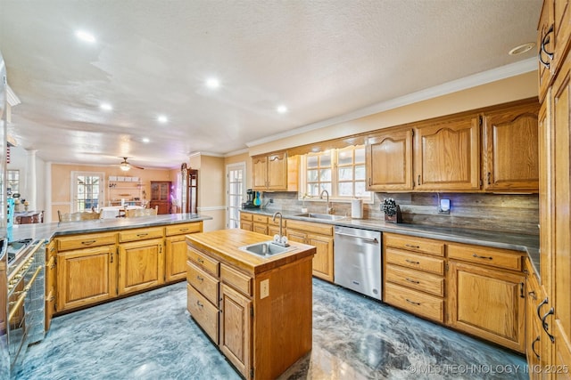 kitchen featuring decorative backsplash, a center island with sink, dishwasher, and a sink