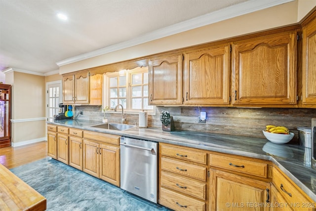 kitchen with a sink, baseboards, stainless steel dishwasher, tasteful backsplash, and crown molding