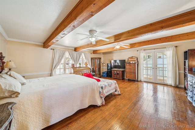 bedroom featuring french doors, multiple windows, beam ceiling, and hardwood / wood-style flooring