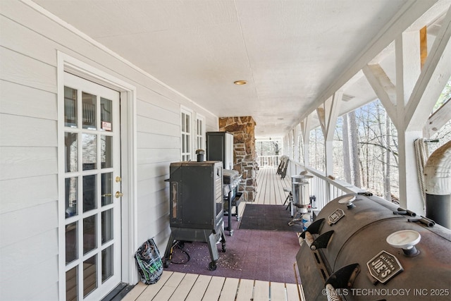 wooden deck featuring a porch and area for grilling