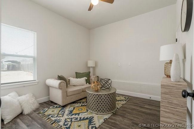 sitting room featuring a ceiling fan, baseboards, and wood finished floors