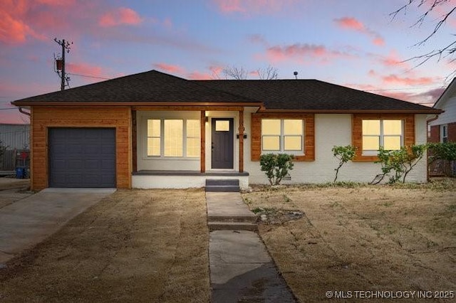 ranch-style home featuring a garage and driveway