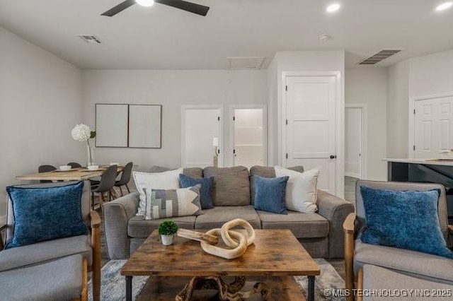 living room featuring ceiling fan, visible vents, and recessed lighting