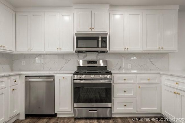 kitchen featuring white cabinets, tasteful backsplash, and stainless steel appliances