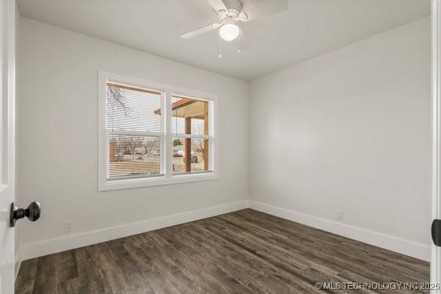 unfurnished room with dark wood-style floors, baseboards, and a ceiling fan