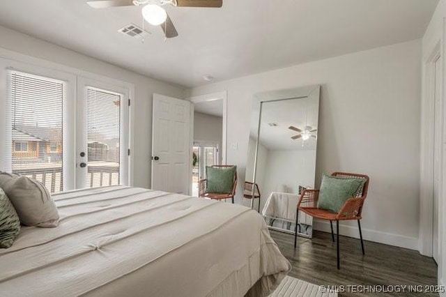 bedroom featuring ceiling fan, multiple windows, wood finished floors, and baseboards