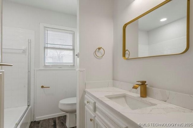 bathroom with shower / tub combination, vanity, toilet, and wood finished floors