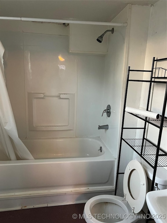 full bathroom with shower / tub combo, a sink, and toilet