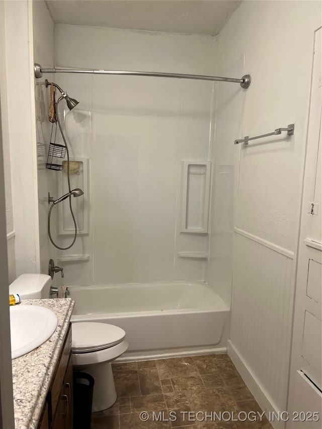 bathroom featuring bathtub / shower combination, vanity, and toilet