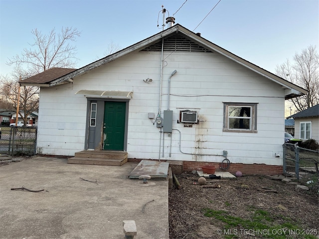 back of house featuring entry steps and fence