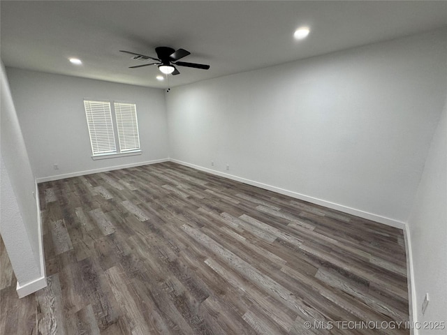 spare room with dark wood-type flooring, recessed lighting, baseboards, and a ceiling fan