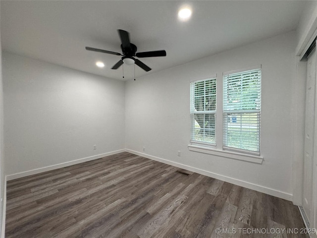 unfurnished room with dark wood-type flooring, recessed lighting, baseboards, and a ceiling fan