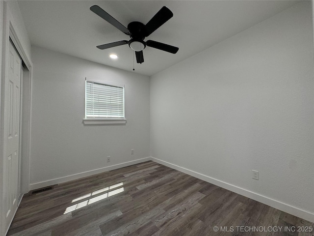 unfurnished bedroom with visible vents, a closet, baseboards, and wood finished floors