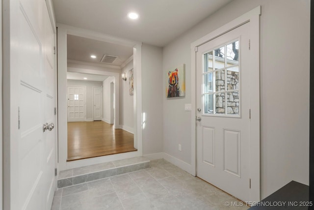 foyer with recessed lighting, visible vents, and baseboards