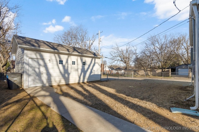 view of yard featuring an outdoor structure and fence