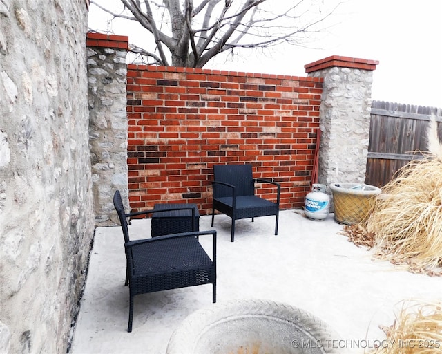 view of patio / terrace featuring fence