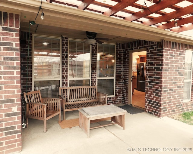 view of patio / terrace featuring a ceiling fan and a pergola