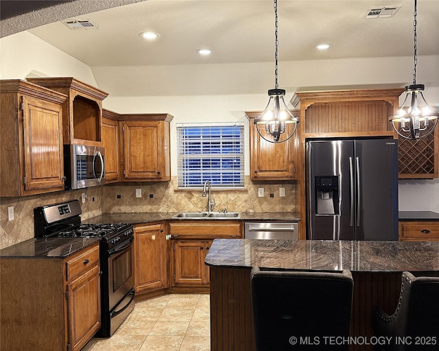 kitchen featuring stainless steel appliances, visible vents, a sink, and decorative backsplash