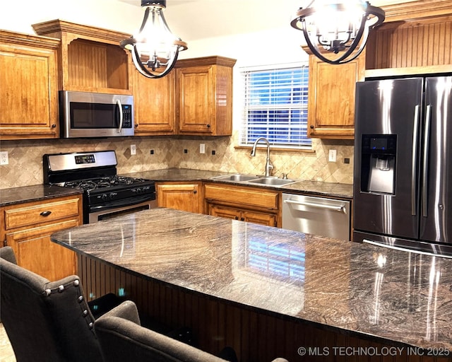 kitchen with stainless steel appliances, a chandelier, a sink, and tasteful backsplash