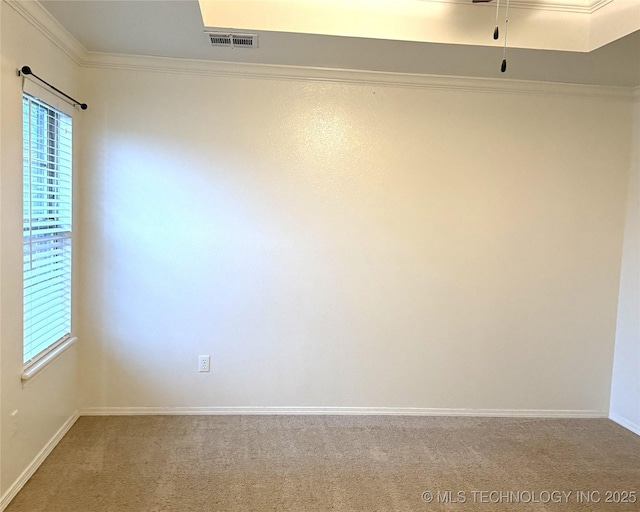 carpeted empty room with ornamental molding, visible vents, and baseboards