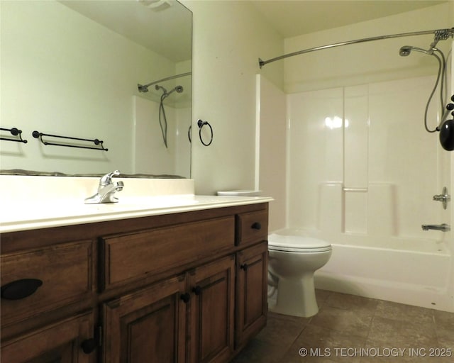 bathroom featuring toilet, shower / bath combination, tile patterned flooring, and vanity