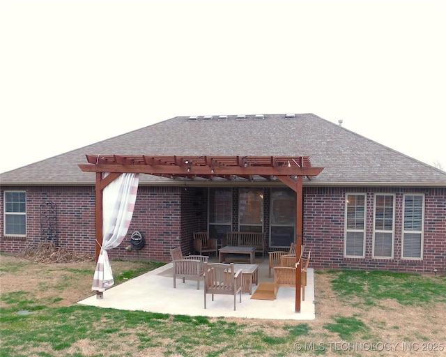 back of house with a shingled roof, a patio, an outdoor hangout area, a pergola, and brick siding