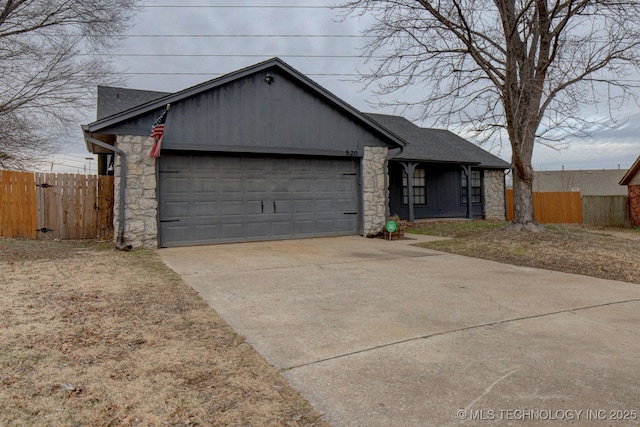 ranch-style house with driveway, a garage, a shingled roof, stone siding, and fence