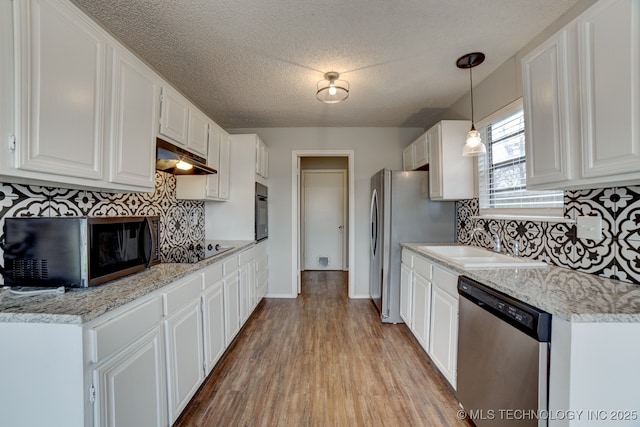 kitchen featuring black appliances, white cabinetry, and a sink