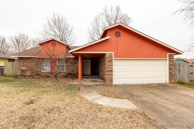 ranch-style house featuring a garage, concrete driveway, brick siding, and fence