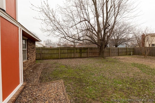 view of yard with a fenced backyard