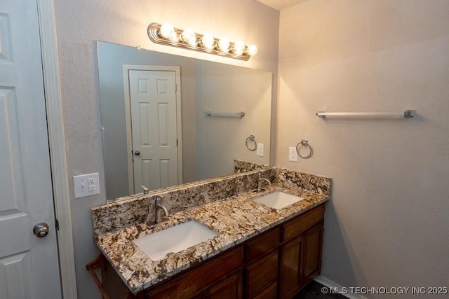 bathroom with a sink and double vanity