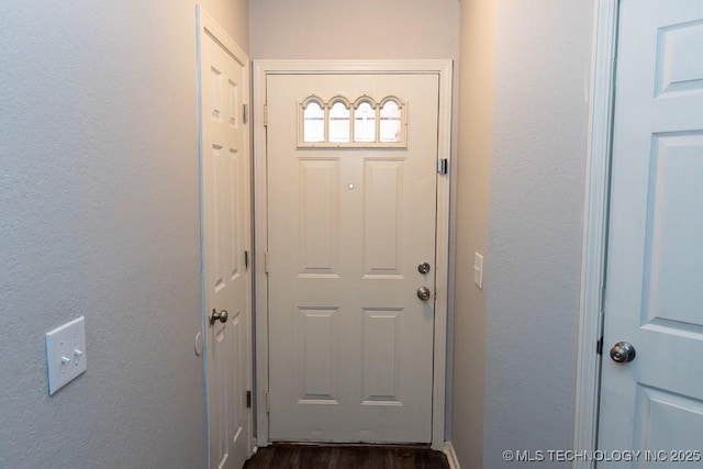 doorway with dark wood-type flooring