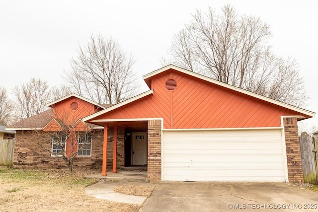 single story home with a garage, fence, concrete driveway, and brick siding