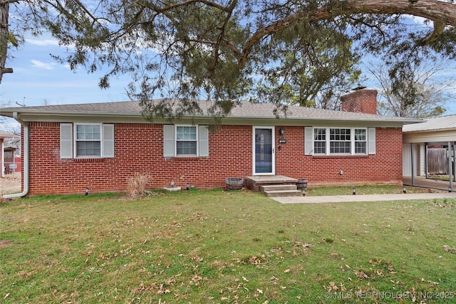 ranch-style house featuring a chimney, a front lawn, and brick siding