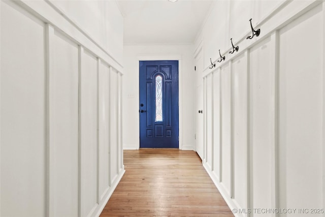 mudroom with ornamental molding and light wood finished floors