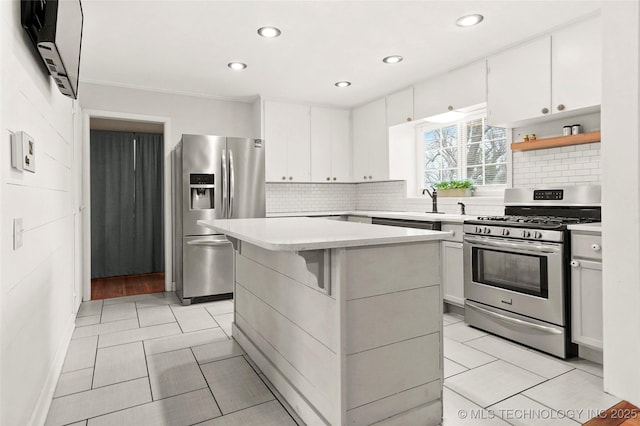 kitchen featuring white cabinetry, stainless steel appliances, light countertops, and light tile patterned flooring