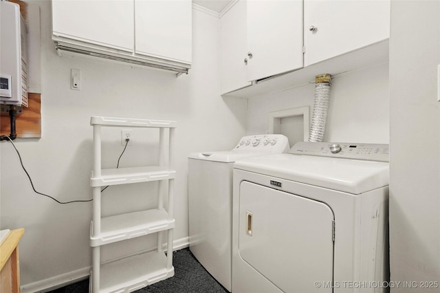 clothes washing area featuring washing machine and dryer, cabinet space, baseboards, and water heater