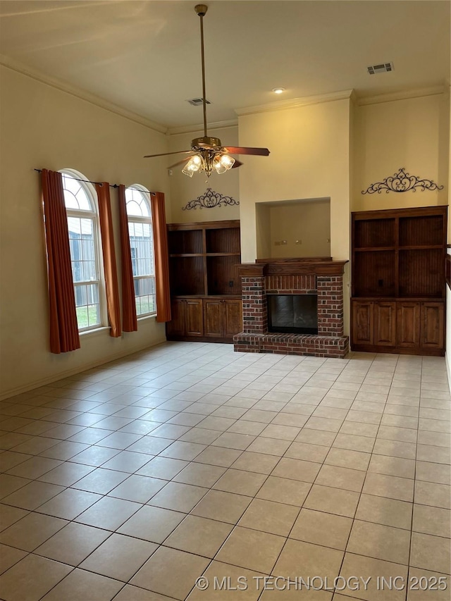 unfurnished living room with light tile patterned floors, a fireplace, visible vents, and crown molding