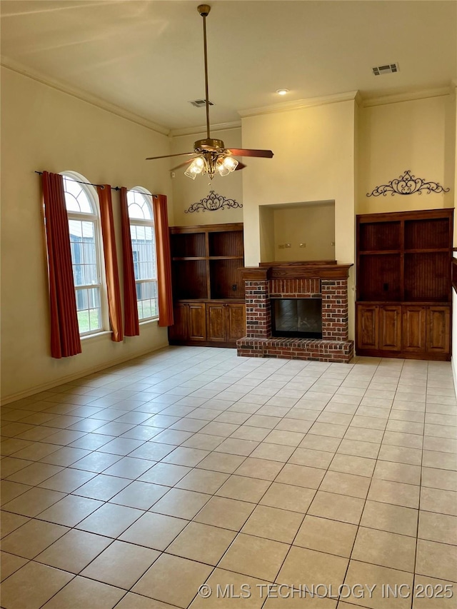 unfurnished living room with light tile patterned floors, a fireplace, visible vents, and crown molding